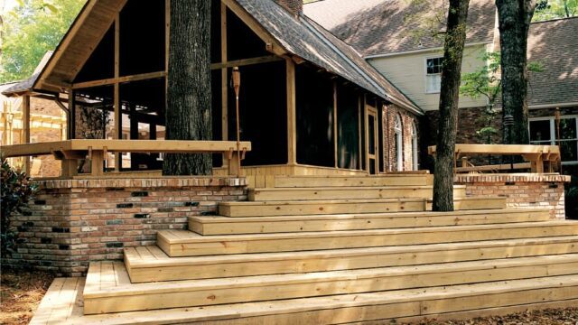 Wooden steps leading up to a porch on a red brick building