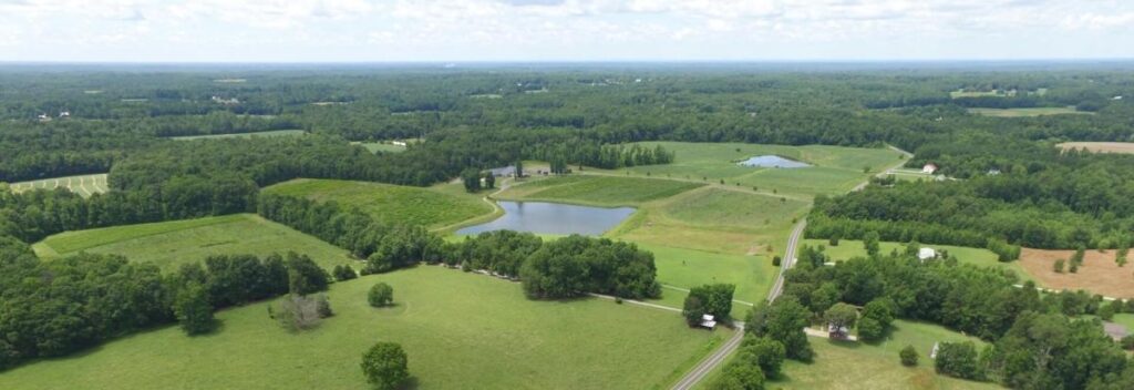 An exterior photo of green fields and trees