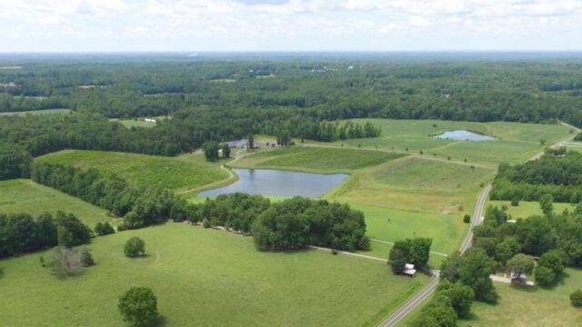 An exterior photo of green fields and trees