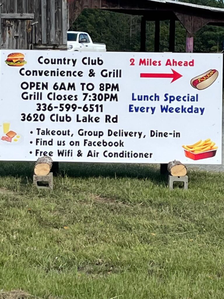 A sign for Country Club Convenience & Grill