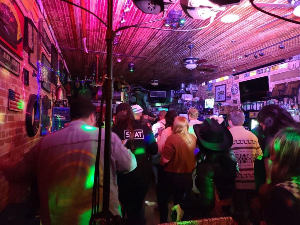 People stand in a sports bar