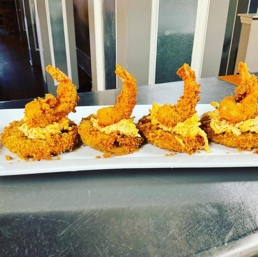 A white rectangular plate with fried shrimp