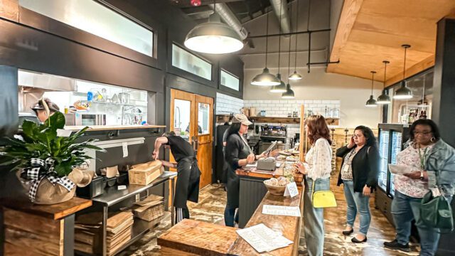 A woman orders at a counter at Incorrigible Cafe