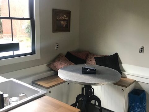 A small round table in front of banquette seating