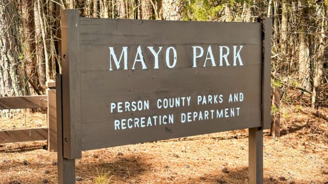 Mayo Park sign on a forest trail