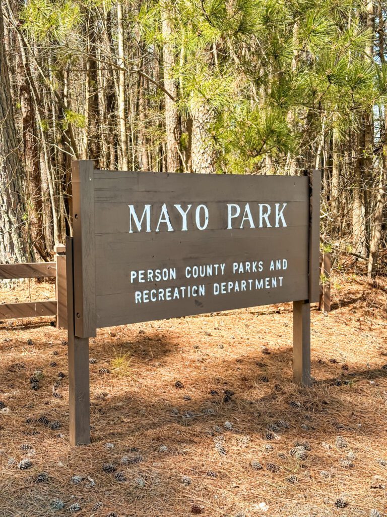 Mayo Park sign on a forest trail