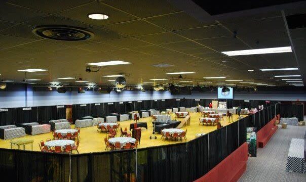 Round tables with red chairs set inside a mesh enclosure