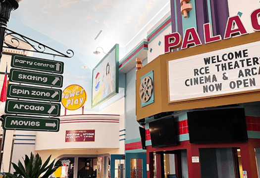 An elevated sign gives directions to different entertainment areas