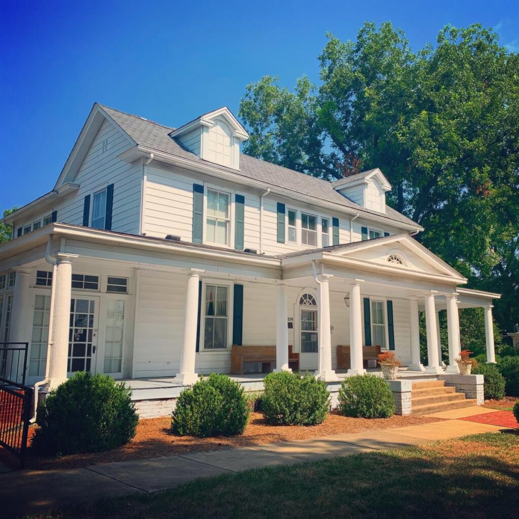 The white clapboard two-story Person County Museum of History