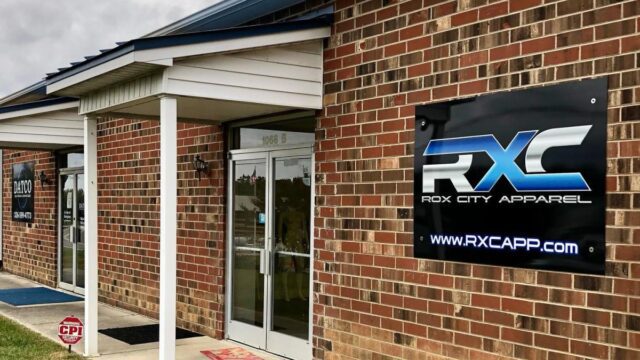 The front entrance to Rox City Apparel in a red brick building