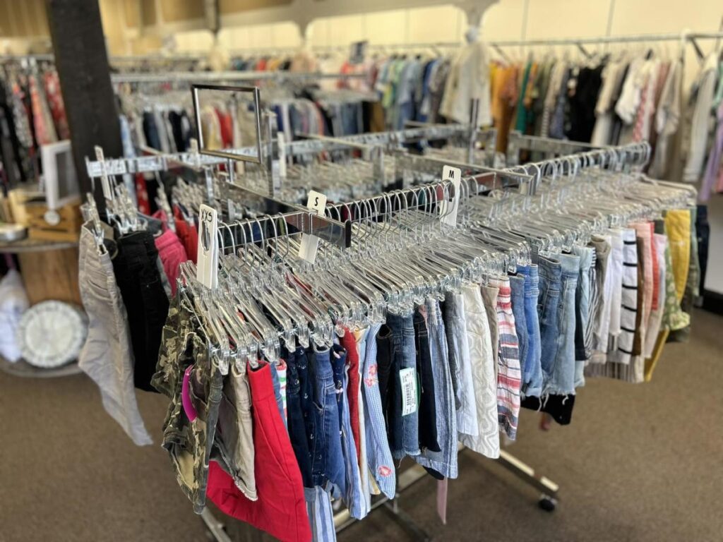 Metal racks with clothing inside a thrift store