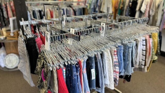 Metal racks with clothing inside a thrift store