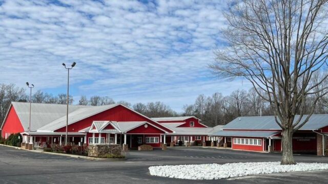 The red exterior and parking lot of The Homestead Steakhouse