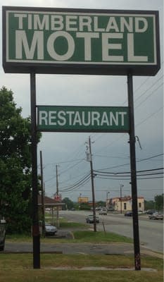A tall sign for Timberland Motel and restaurant