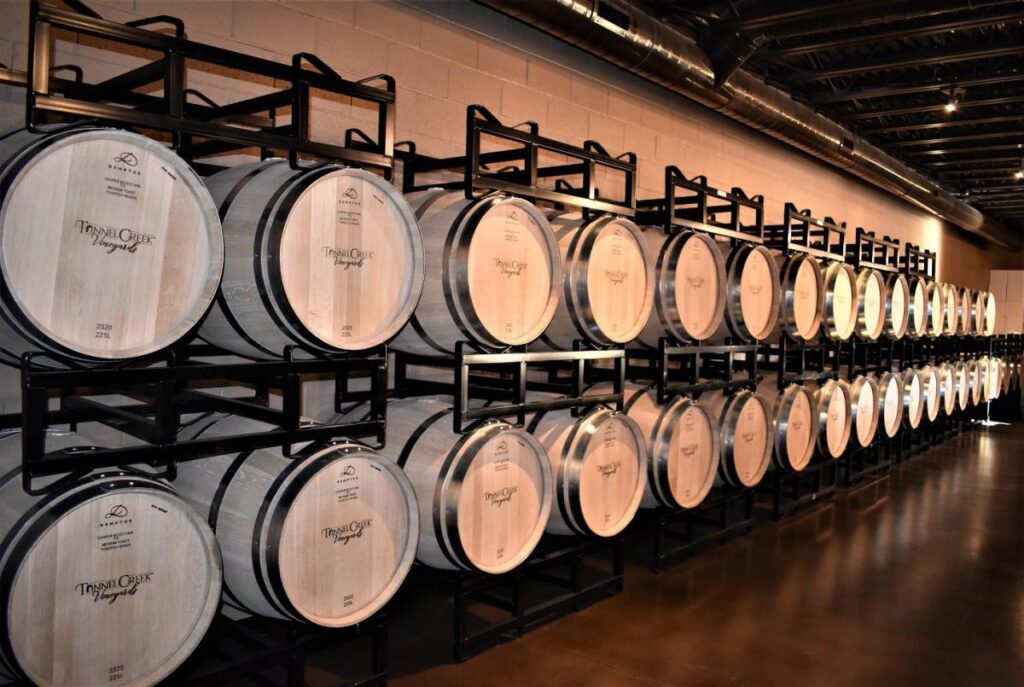 Wooden barrels stored horizontally at a vineyard