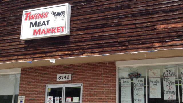 Entrance to the Twins Meat Market in a red brick building