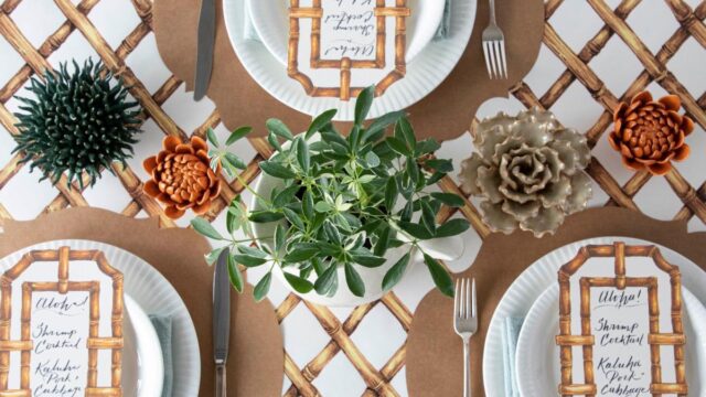 Table settings with white plates, brown placements and flower centerpieces