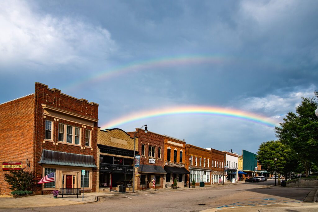 A double rainbow over red brick buildings