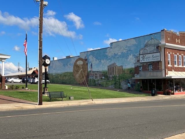A mural of Roxboro painted on the side of a red brick building