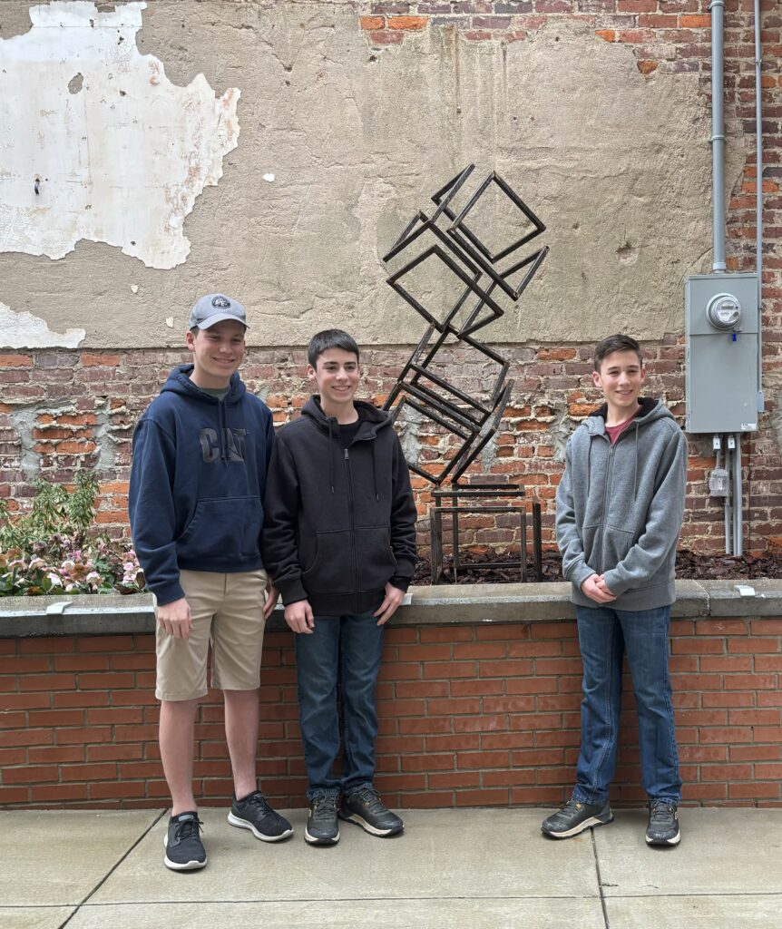 Metal Sculpture in Roxboro Savings Centennial park with artist Caleb, Carter, & Camden White